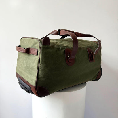 Maxwell waxed canvas rolling duffel bag in olive green with brown leather trim on Tampa Home & Garden Store