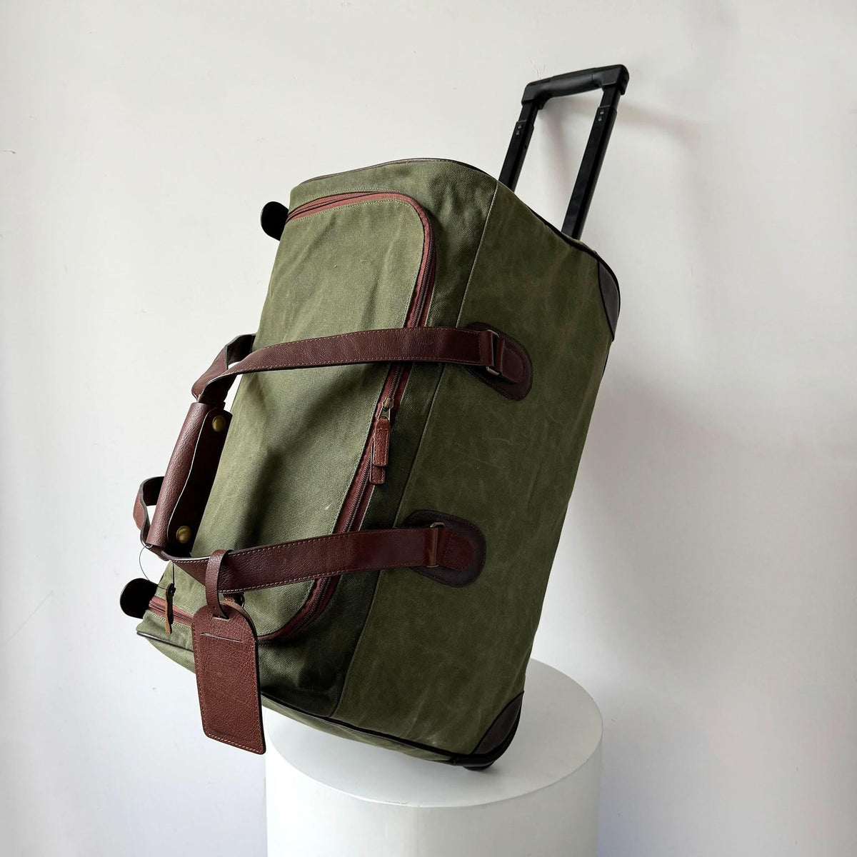 Maxwell waxed canvas rolling duffel bag olive green with brown leather straps and handle on Tampa Home & Garden Store