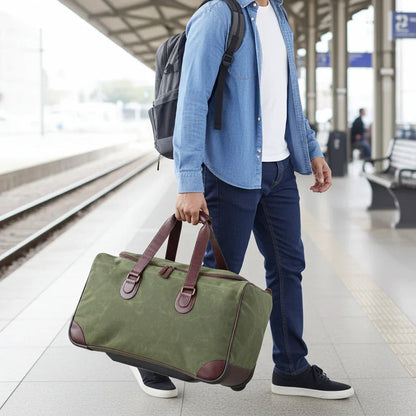 Maxwell waxed canvas rolling duffel bag in olive green with brown leather handles on Tampa Home & Garden Store.