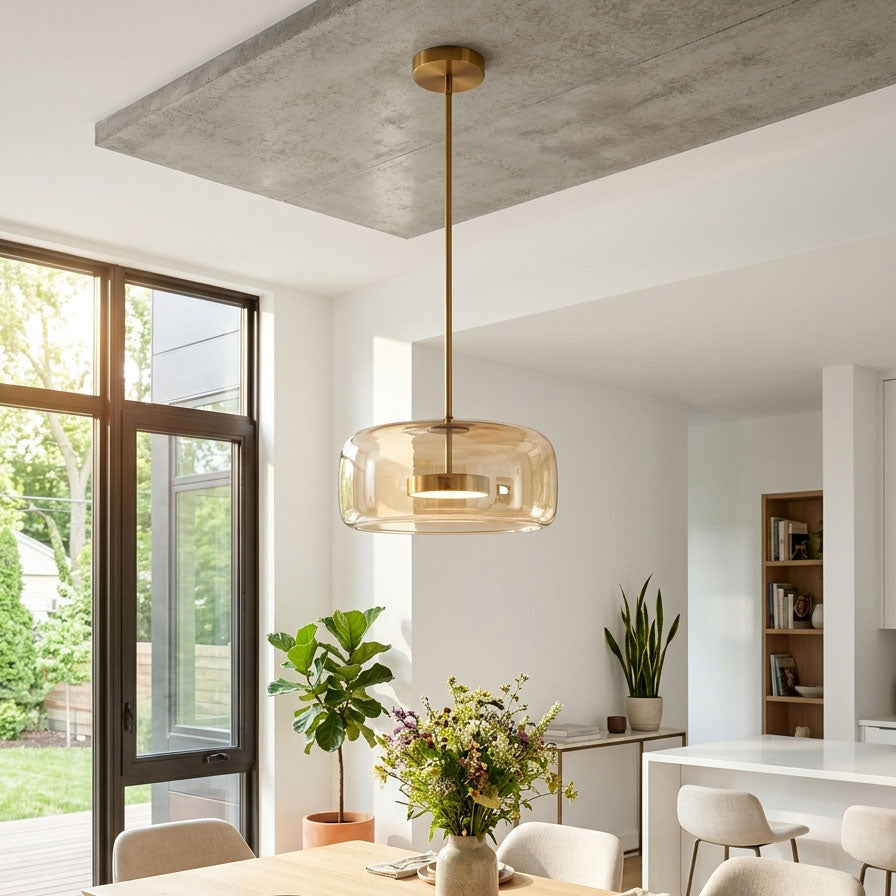 Hand-blown glass sphere pendant light with warm LED, amber smoke shade and brass hardware on Tampa Home & Garden Store