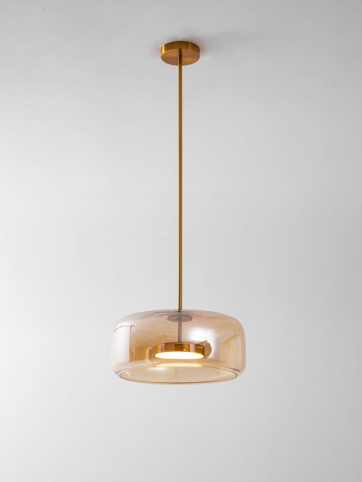 Hand-blown glass sphere pendant light with warm LED amber shade brass stem on Tampa Home & Garden Store