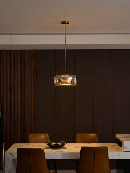 Hand-blown glass sphere pendant light by Moktan Sabai with amber shade over marble table on Tampa Home & Garden Store