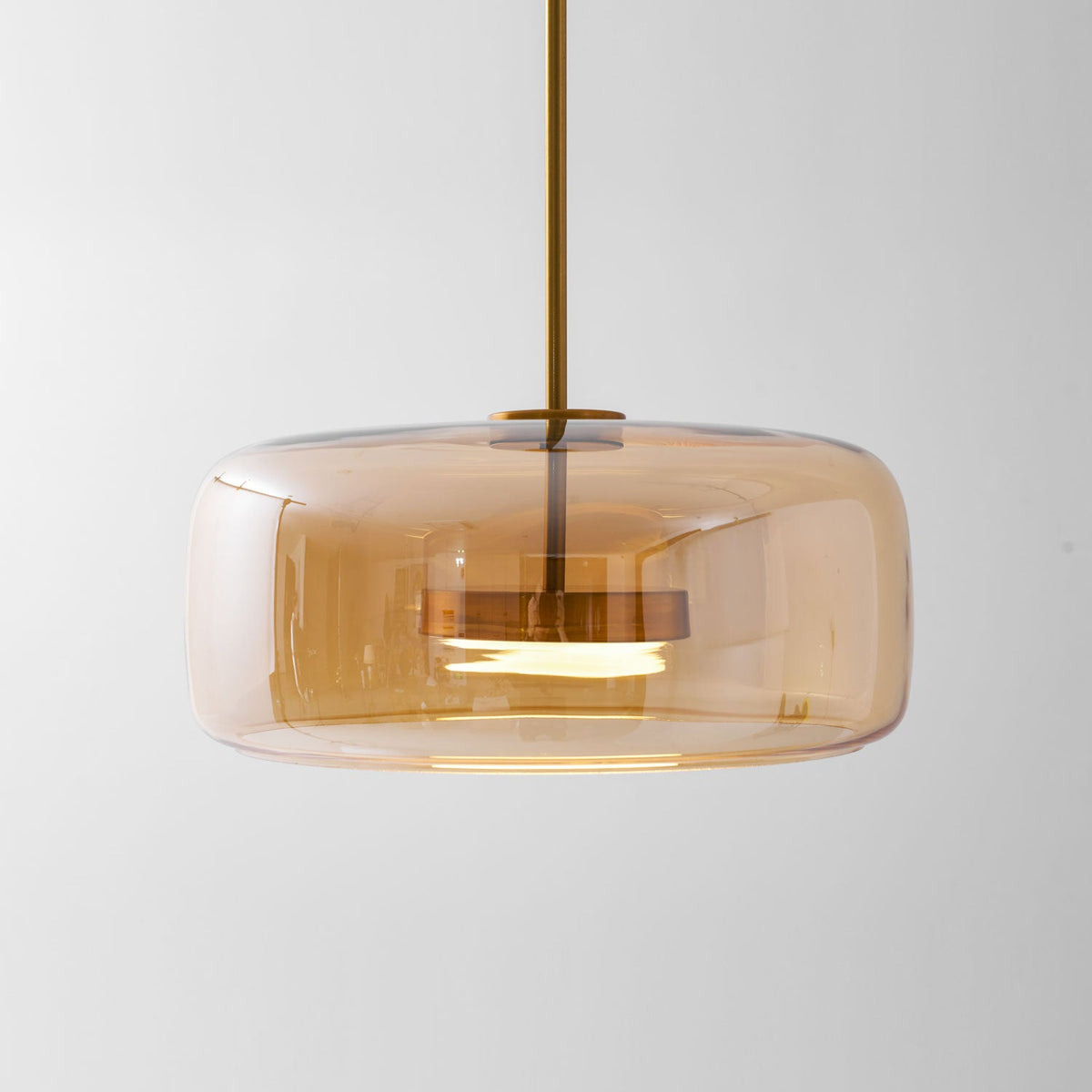 Moktan Sabai hand-blown glass sphere pendant light amber shade with warm LED brass stem on Tampa Home & Garden Store