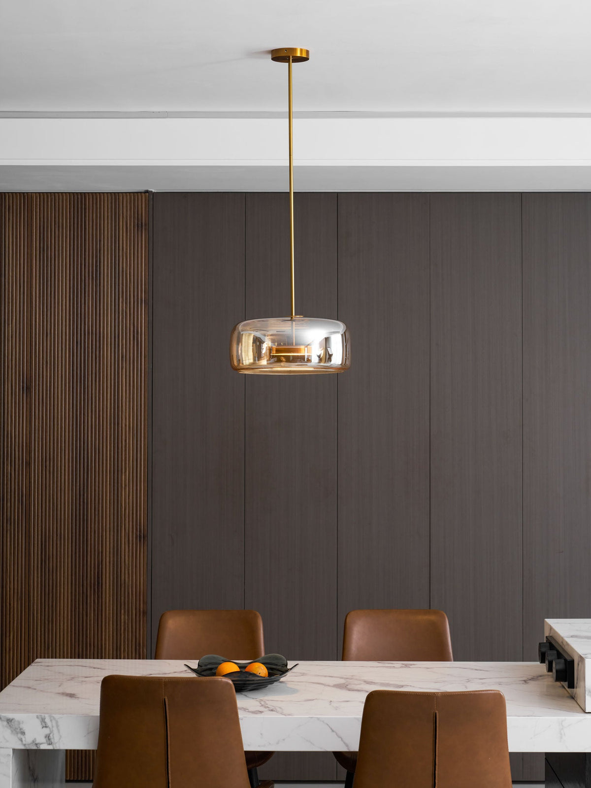 Hand-blown glass sphere pendant light by Moktan Sabai with warm LED, amber shade, gold stem on Tampa Home & Garden Store