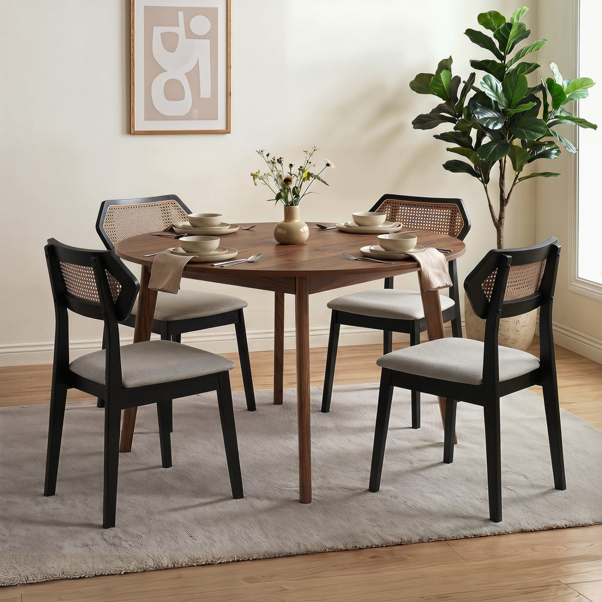 Rattan dining chairs set of 4 with curved backs, black frames and cushions around round table on Tampa Home & Garden Store