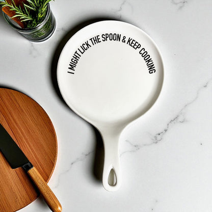 Lick the Spoon & Cook spoon rest by Gia Roma, white ceramic with black slogan on countertop on Tampa Home & Garden Store