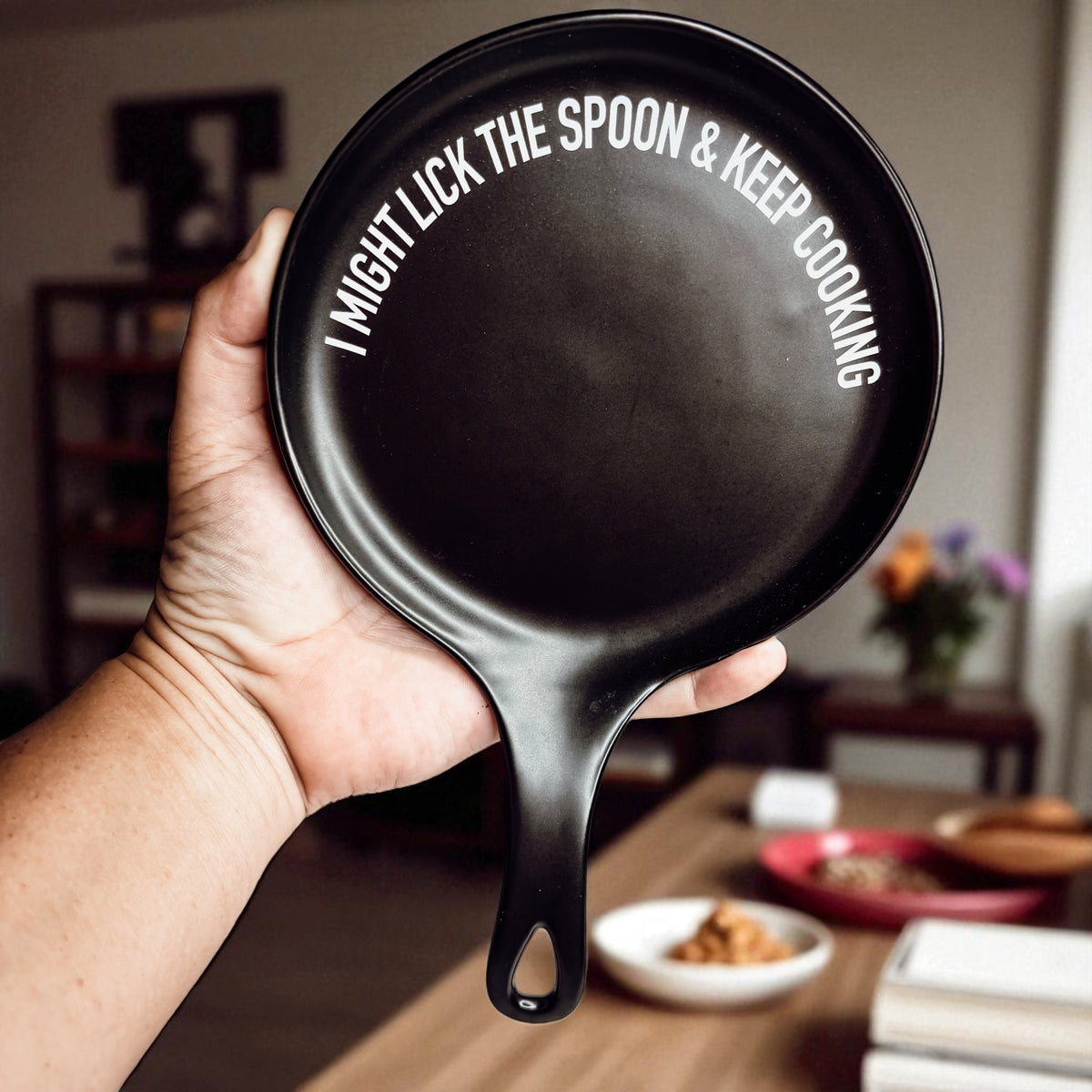 Lick the Spoon & Cook spoon rest by Gia Roma, black round skillet with white slogan on Tampa Home & Garden Store