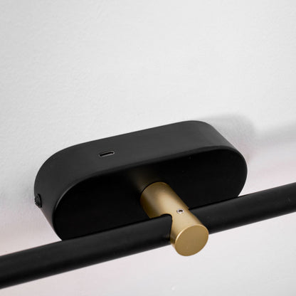 Rechargeable LED wall lamp Moktan Sabai with black metal housing and brass hinge on Tampa Home & Garden Store