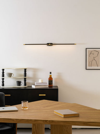 Rechargeable linear LED wall lamp by Moktan Sabai, black bar with brass ends, remote light on Tampa Home & Garden Store