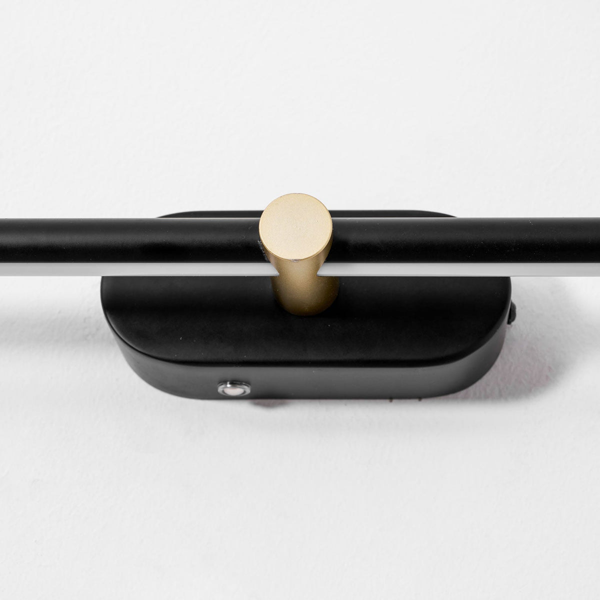 Rechargeable linear LED wall lamp with black metal bar and gold circular connector on Tampa Home & Garden Store