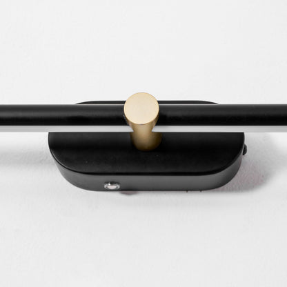 Rechargeable linear LED wall lamp with black metal bar and gold circular connector on Tampa Home & Garden Store