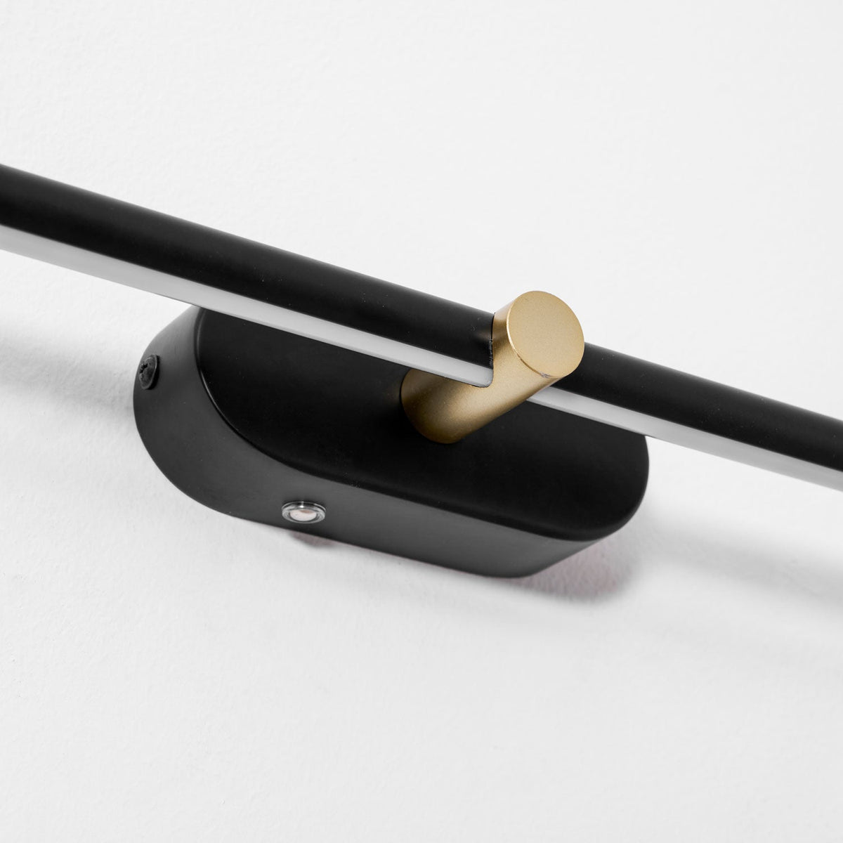 Rechargeable linear LED wall lamp by Moktan Sabai with black bar and gold accent joint on Tampa Home & Garden Store