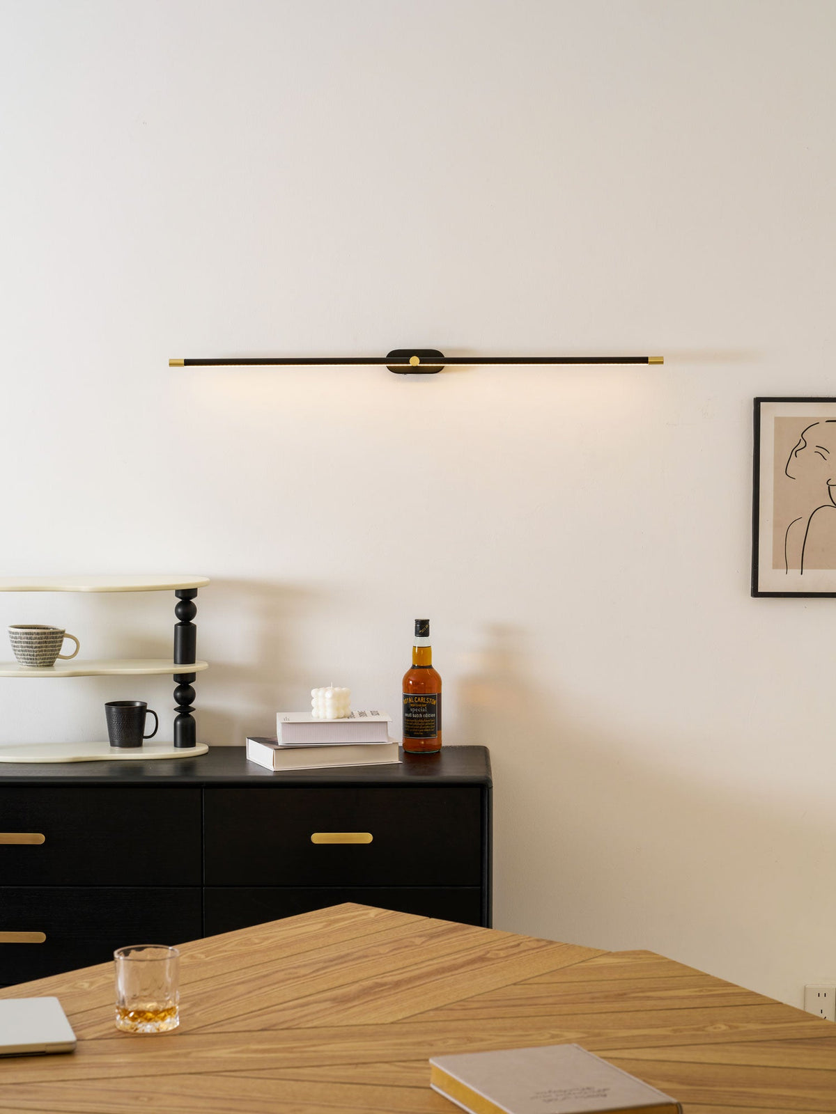 Rechargeable linear LED wall lamp cordless Moktan Sabai, black bar with brass ends, remote on Tampa Home & Garden Store