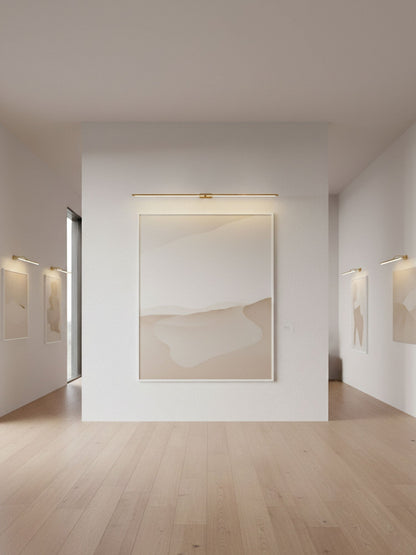 Rechargeable linear LED wall lamp with remote in goldtone, cordless mirror light above artwork on Tampa Home & Garden Store