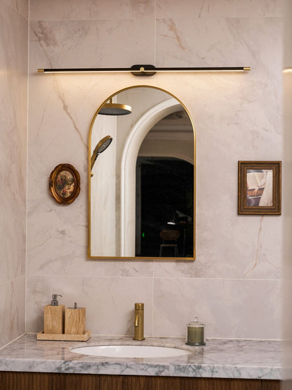 Rechargeable linear LED wall light with remote, black bar with gold ends above gold-framed mirror on Tampa Home & Garden Store