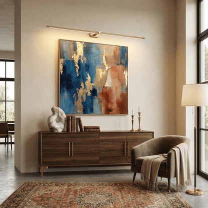 Rechargeable linear LED wall lamp with remote Moktan Sabai, gold finish above painting on Tampa Home & Garden Store