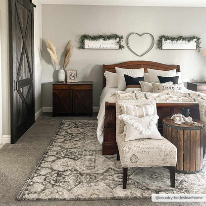 Minoa Area Rug Boutique Rugs, cream and gray patterned bedroom rug under a wooden bed on Tampa Home & Garden Store