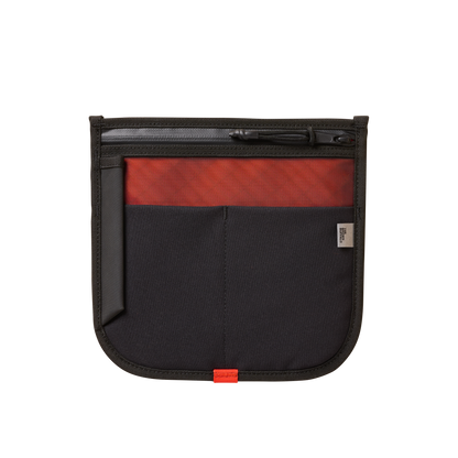 MOD 002 bag by The Brown Buffalo, black with red panel, zipper closure and branded tag visible on Tampa Home & Garden Store