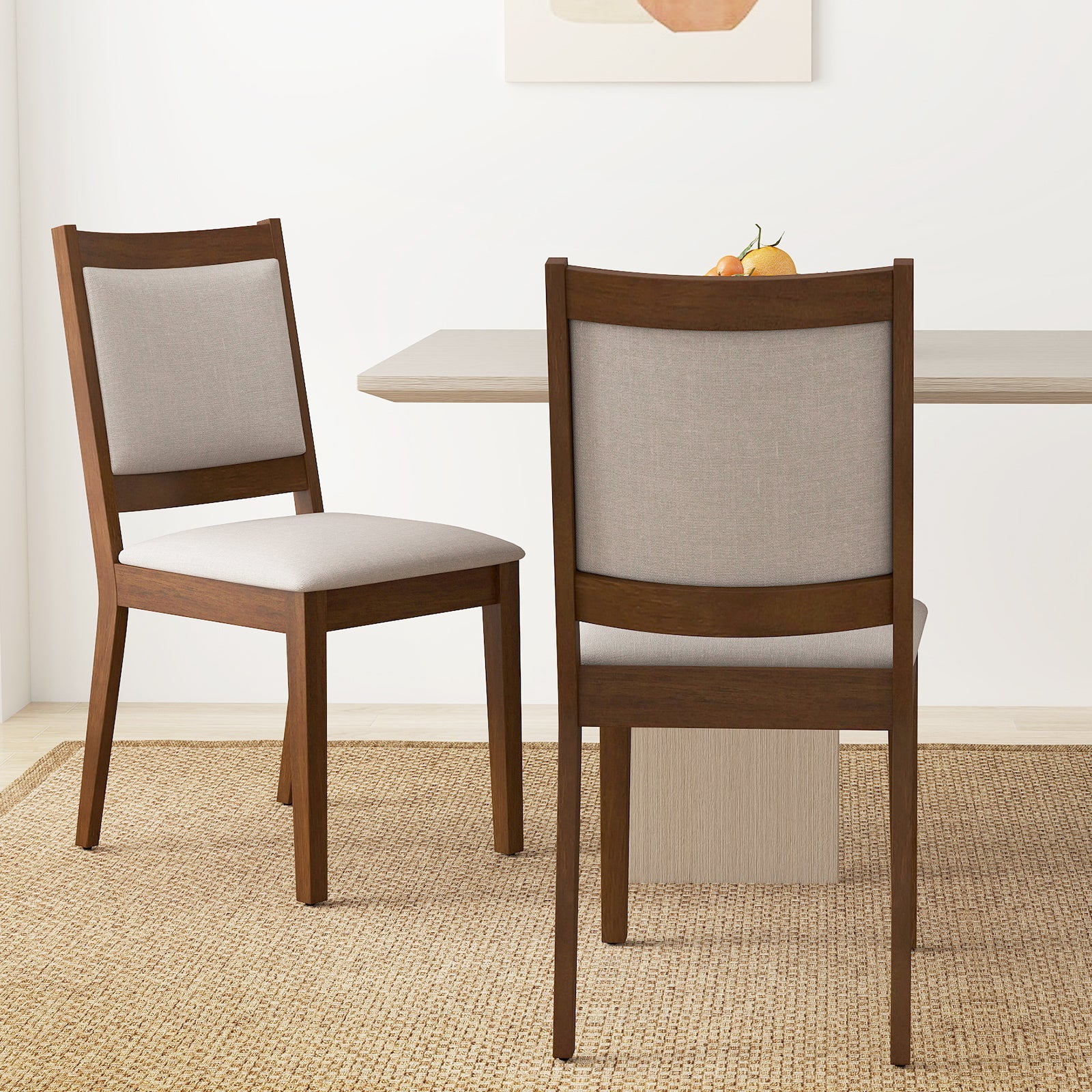 Modern dining chair set of 2 in brown wood with padded gray upholstery at table with fruit on Tampa Home & Garden Store