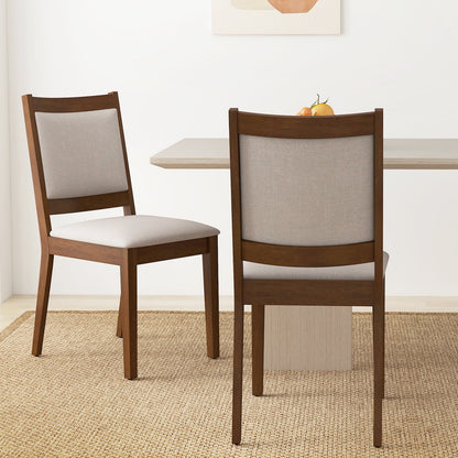 Modern dining chair set of 2 in brown wood with padded gray upholstery at table with fruit on Tampa Home & Garden Store