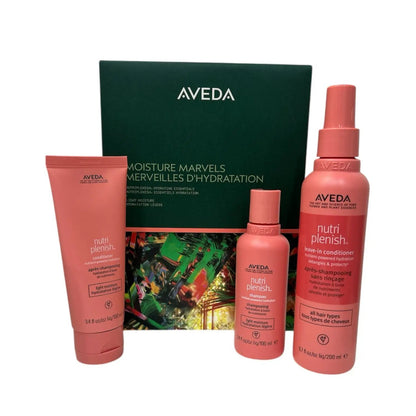 Aveda Moisture Marvels Nutriplenish hair care gift set with 3 pink bottles and a tube beside a green box on Tampa Home & Garden Store