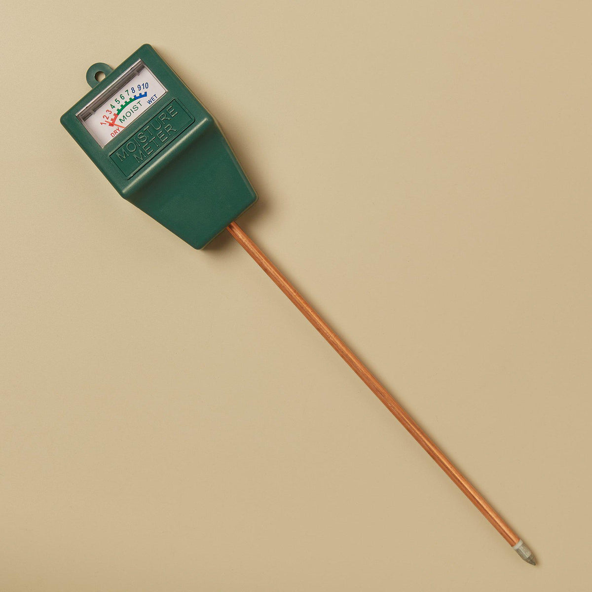 Moisture meter device with green housing, dial gauge, and soil probe on wooden stake on Tampa Home & Garden Store