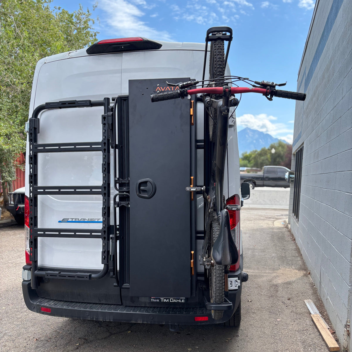 Avatar Centi Van Storage Box dark gray on rear mounting rack with a mounted bike on Tampa Home & Garden Store