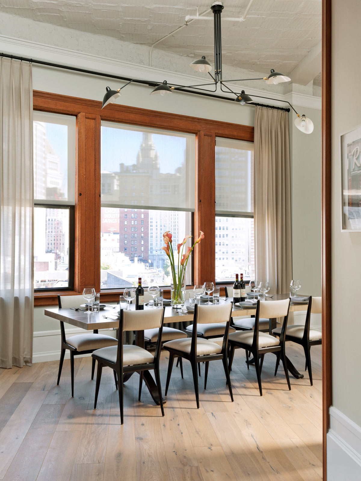Arachnia 3-arm suspended ceiling light with rotating reflectors in black above dining table on Tampa Home & Garden Store