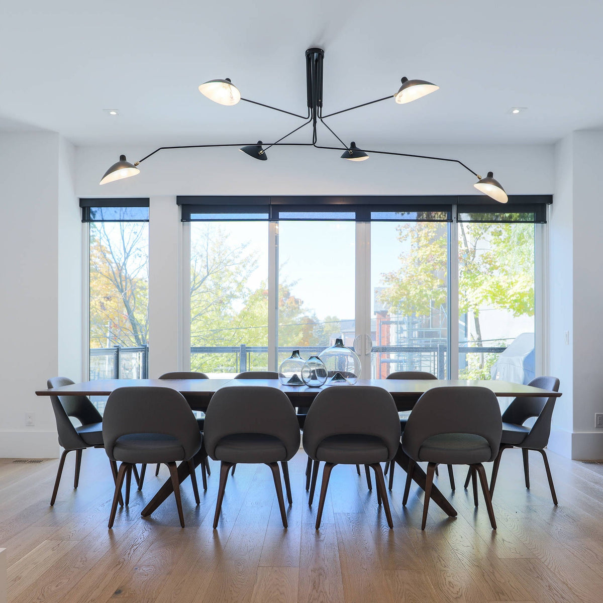 Arachnia 3-arm suspended ceiling light with rotating reflectors in black over dining room table on Tampa Home & Garden Store