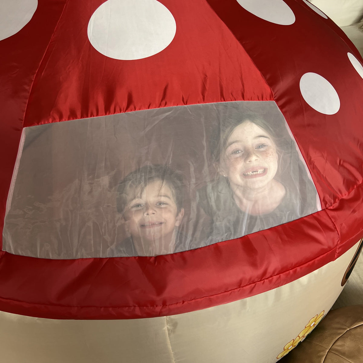 AirFort Mushroom House inflatable play tent with red panels and white polka dots, clear window on Tampa Home & Garden Store
