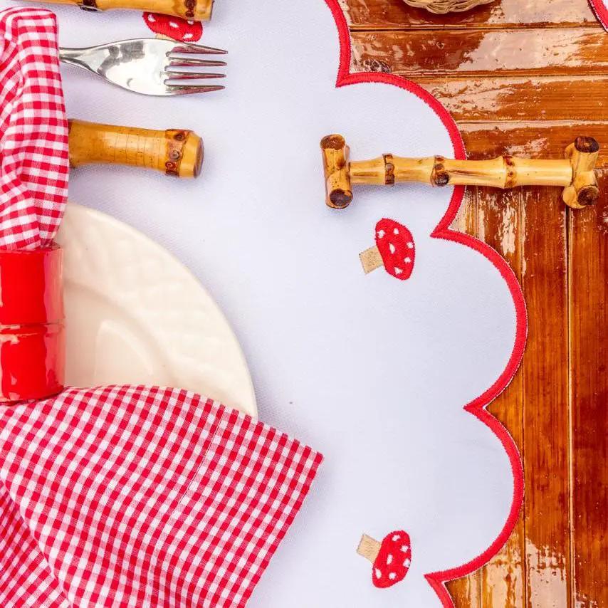 Mushroom placemat by Talah Home with red stitch border on Tampa Home & Garden Store