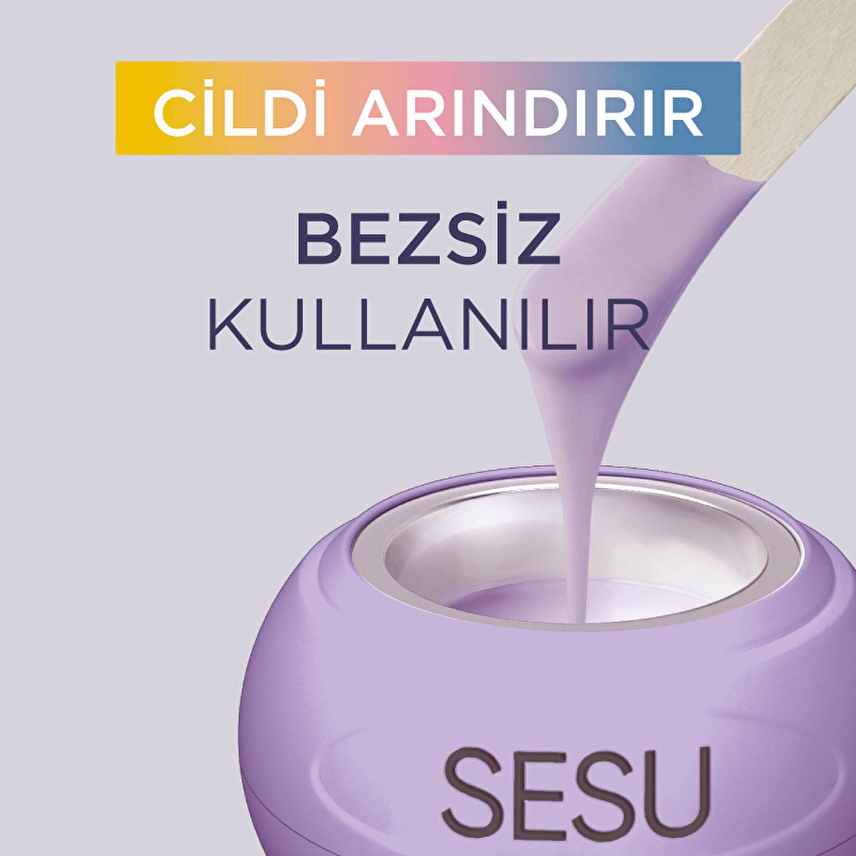 Sesu bead wax jar in lilac with wooden spatula pouring bubble gum scented wax on Tampa Home & Garden Store