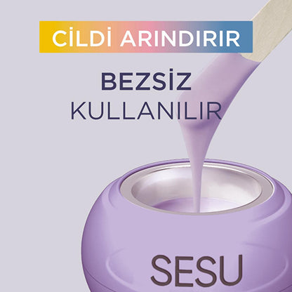 Sesu bead wax jar in lilac with wooden spatula pouring bubble gum scented wax on Tampa Home & Garden Store