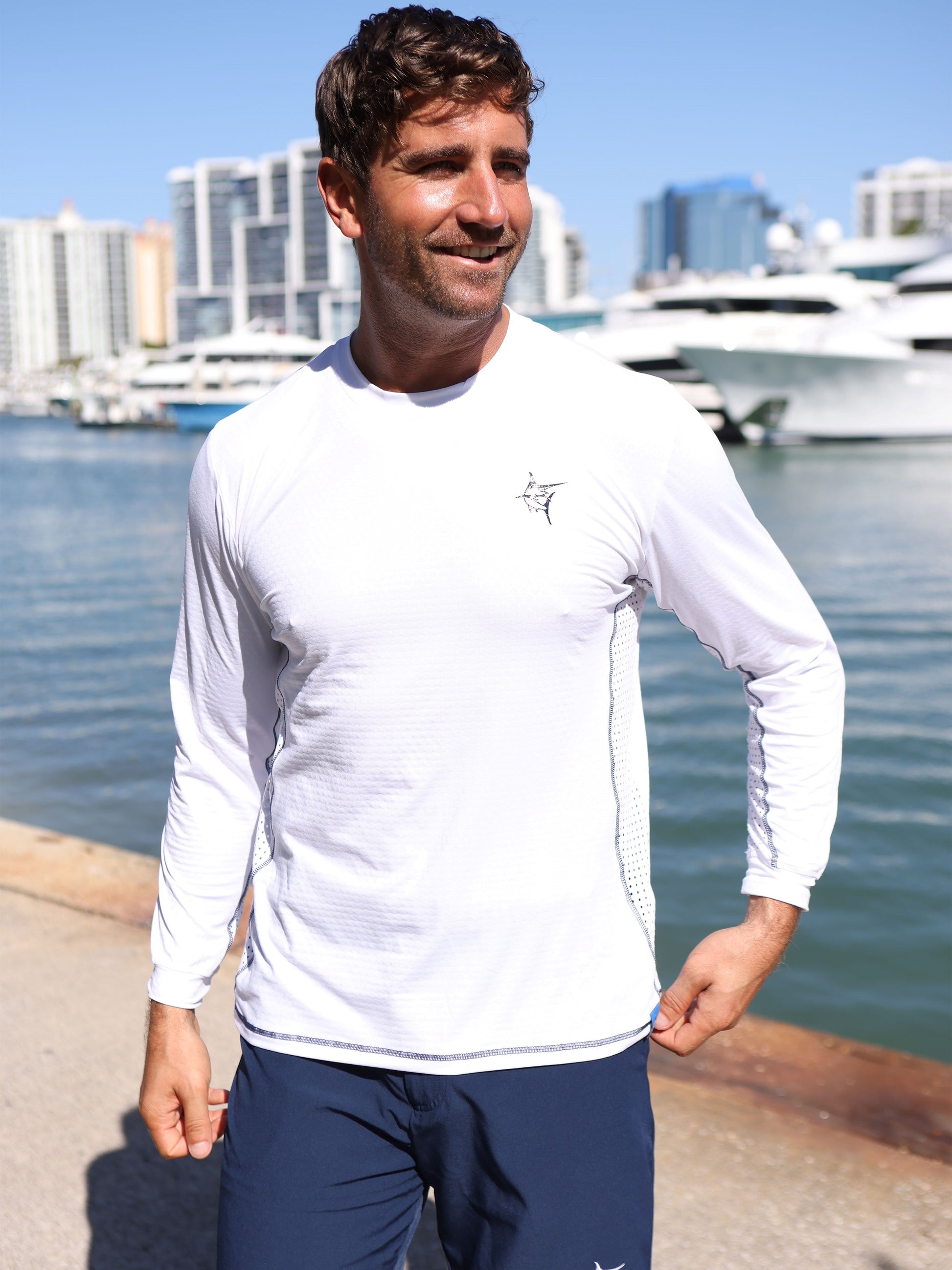 NautiFlex Performance Tee white long-sleeve by White Water Life man at marina on Tampa Home & Garden Store