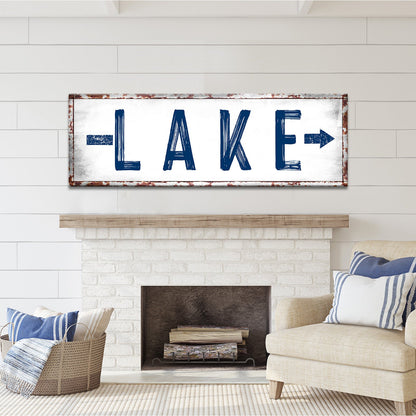 Rustic Lake Arrow Sign canvas wall art with blue LAKE lettering and rust frame on white shiplap on Tampa Home & Garden Store