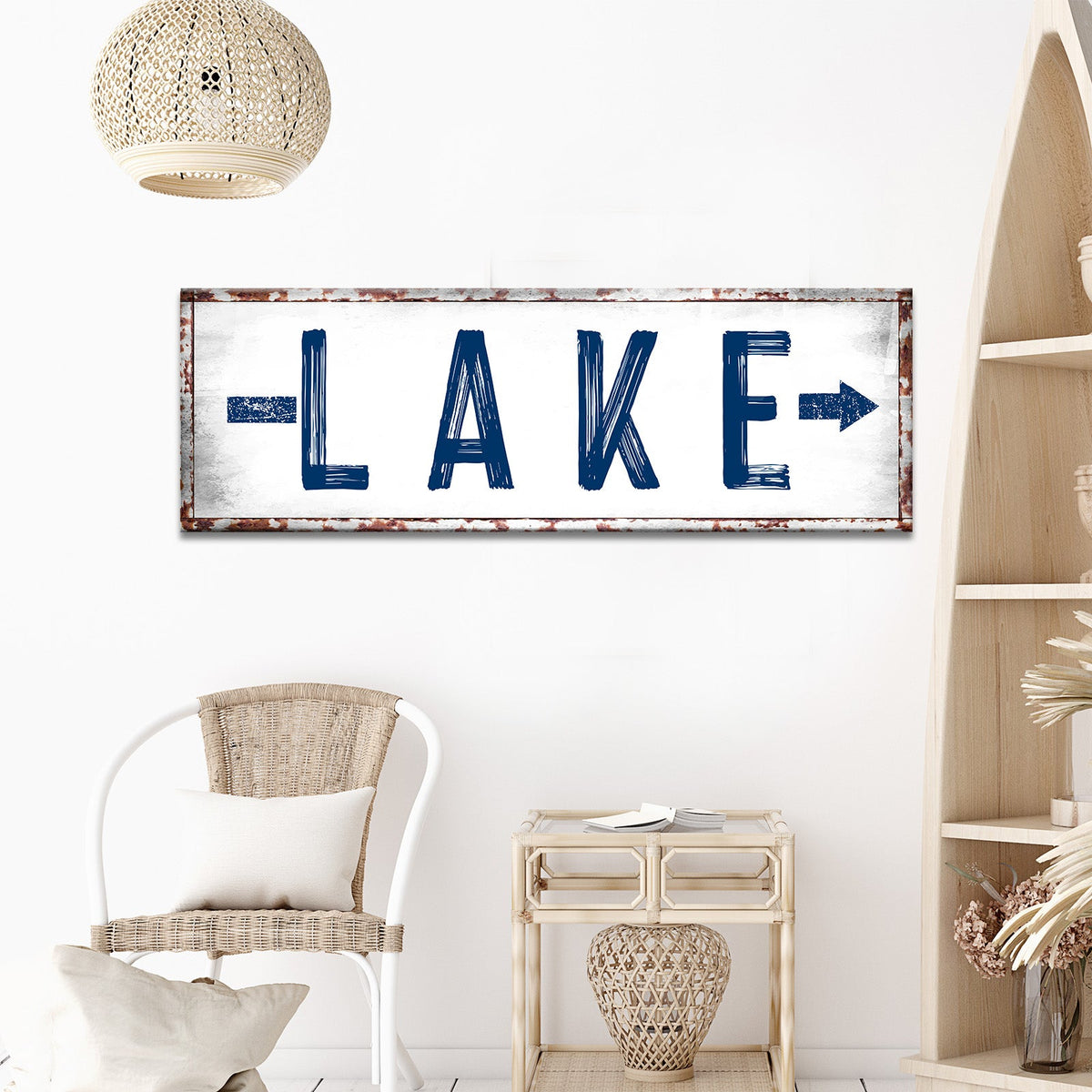 Rustic Lake Arrow Sign canvas with bold blue distressed letters and a rusted frame on Tampa Home & Garden Store