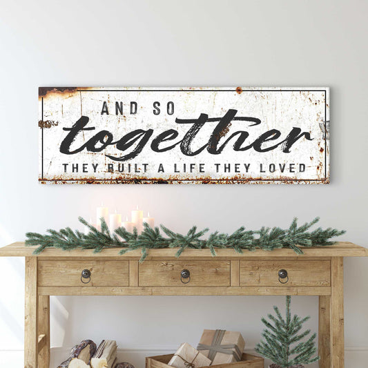Canvas sign with distressed white background, bold black script reading And So Together They Built A Life They Loved on Tampa Home & Garden Store