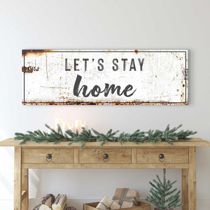 Let's Stay Home Sign canvas wall art, distressed white with black border, rust specks on Tampa Home & Garden Store