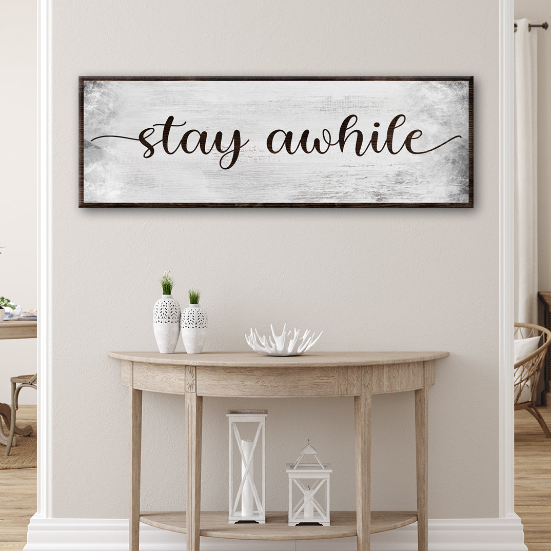 Stay Awhile Sign III canvas wall art, distressed white background with dark wood frame on Tampa Home & Garden Store
