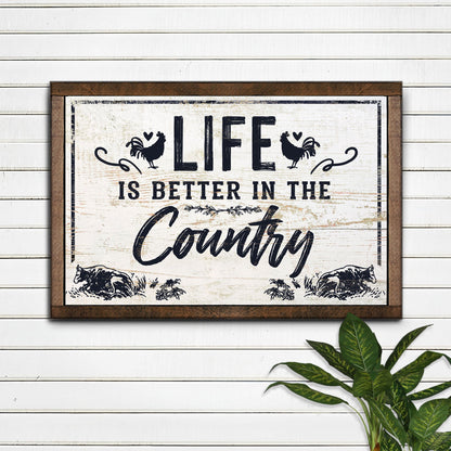 Life Is Better In The Country canvas sign with distressed black lettering and rustic frame on Tampa Home & Garden Store