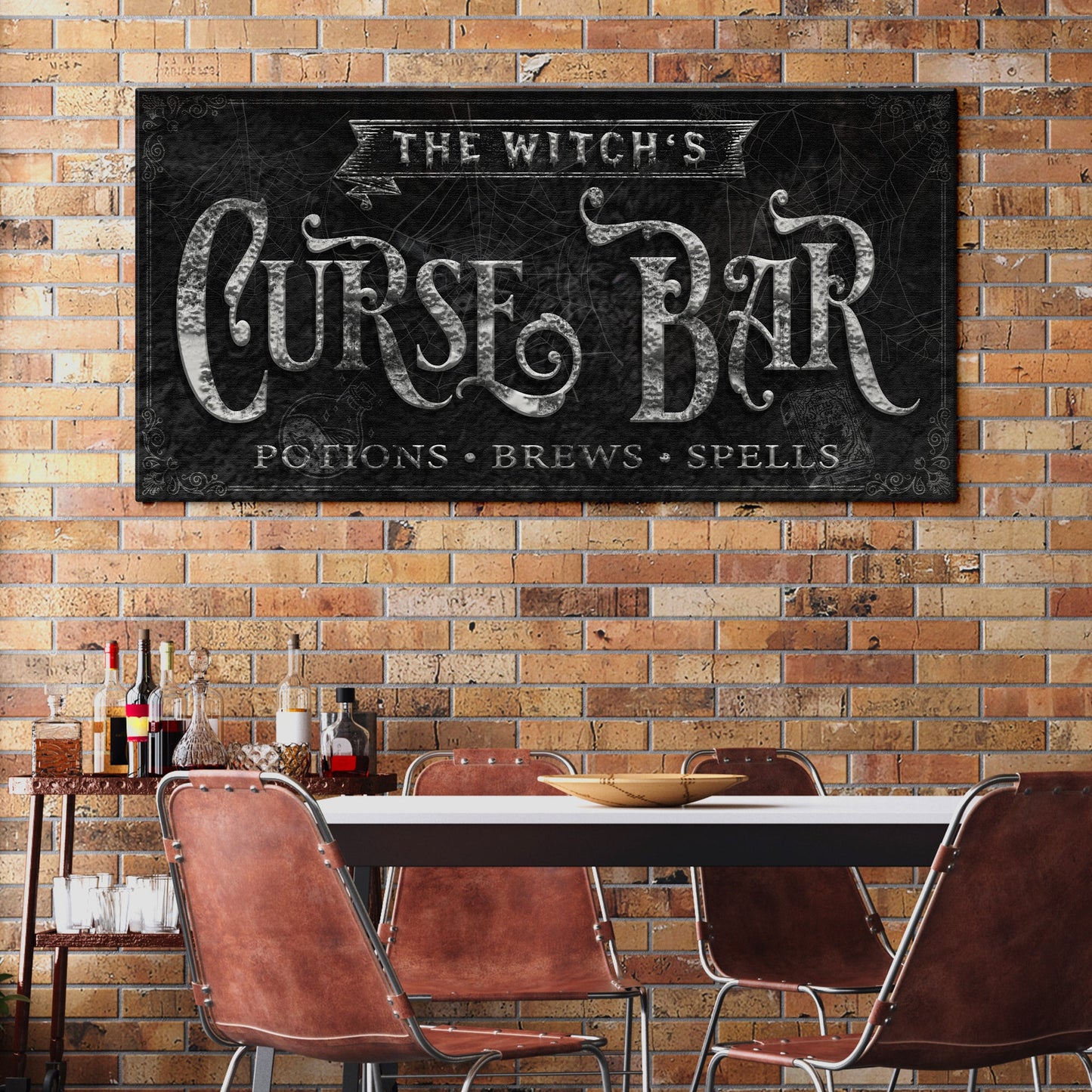 The Witch's Curse Bar canvas sign with chalkboard texture and ornate lettering on wall on Tampa Home & Garden Store