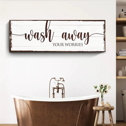 Canvas sign with whitewashed wood and brown frame displaying Wash Away Your Worries on Tampa Home & Garden Store