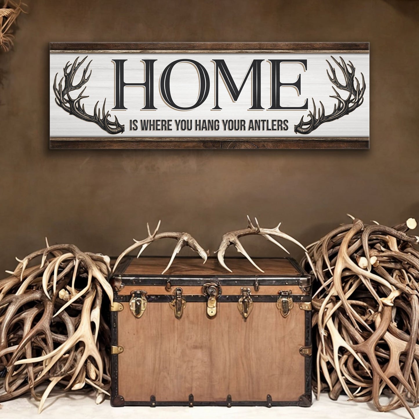 Home Is Where You Hang Your Antlers canvas sign by Tailored Canvases; whitewashed panel with dark wood frame and antler accents on Tampa Home & Garden Store
