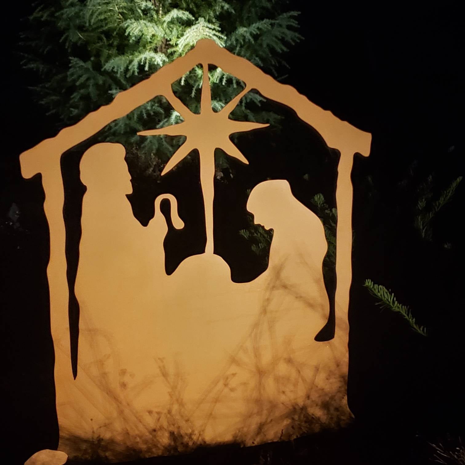 Nativity Scene Outdoor metal silhouette lit with warm amber glow and star above the stable on Tampa Home & Garden Store