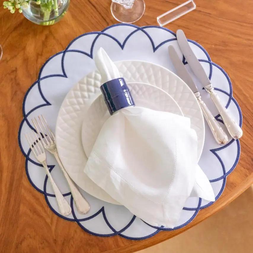 Brazilian Bamboo Napkin Ring by Talah Home on white napkin with blue-rimmed dinner plates on Tampa Home & Garden Store