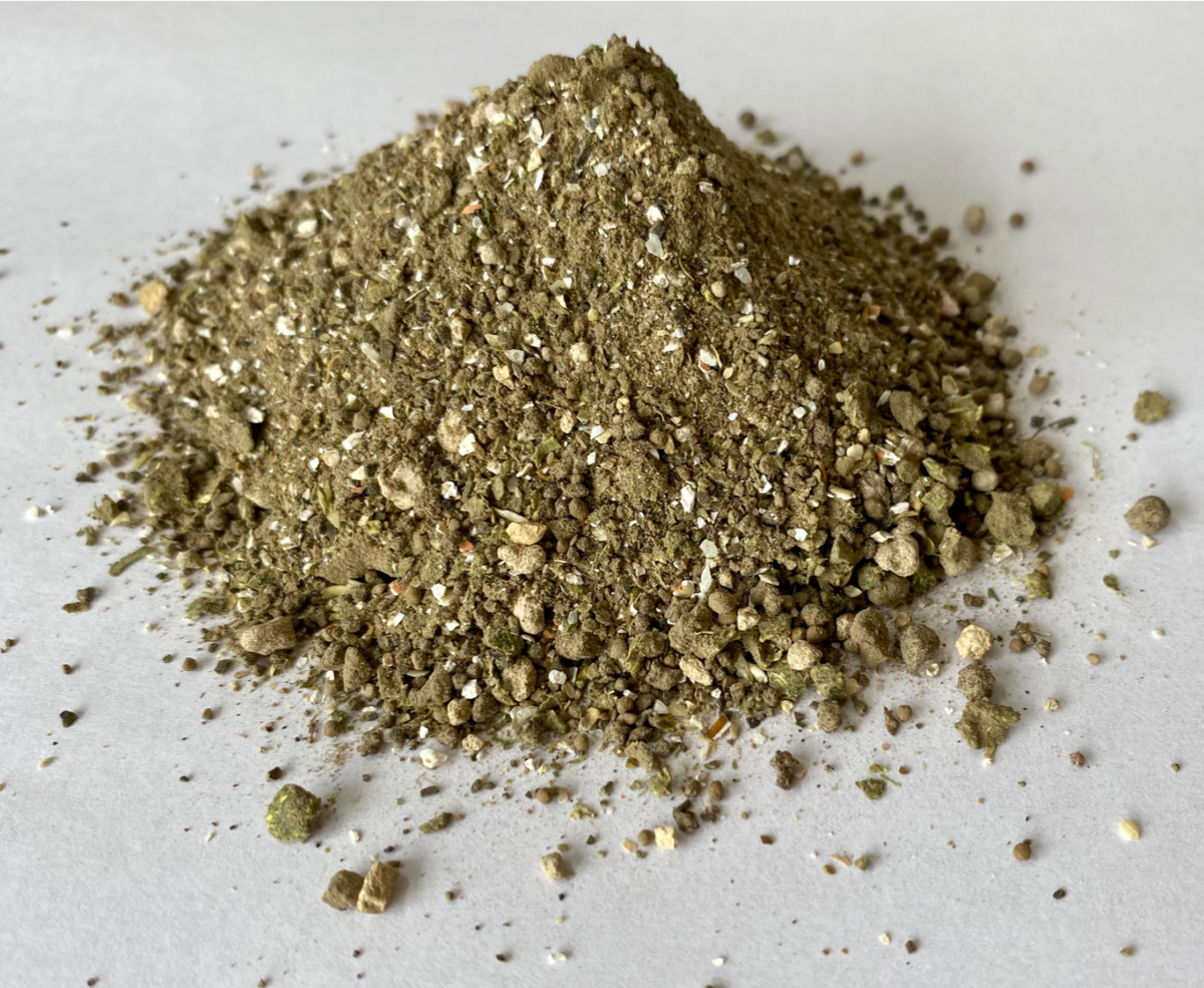 KiS Organics Nutrient Pack soil amendment granules with brown and white specks on gray surface on Tampa Home & Garden Store