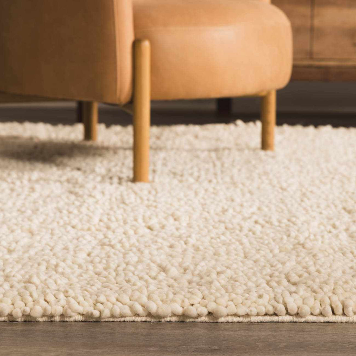 Oakridge area rug by Boutique Rugs in ivory plush shag under a beige sofa on Tampa Home & Garden Store