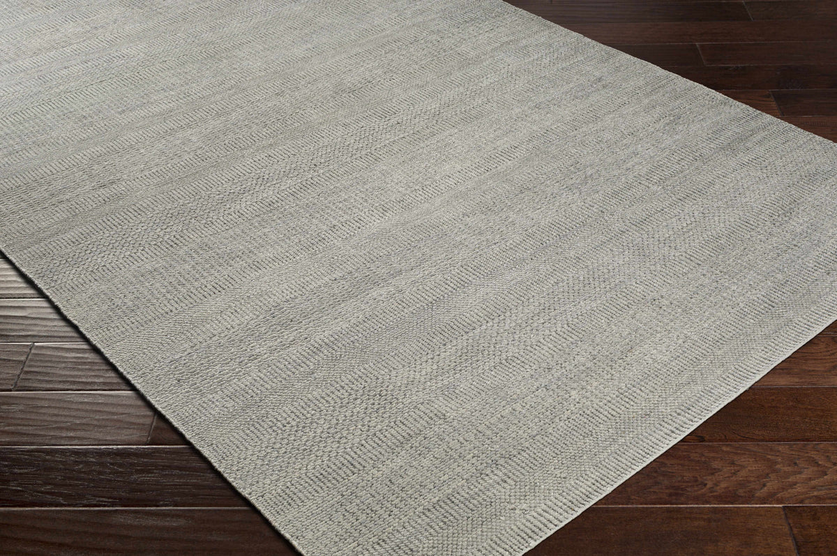 Ocate Gray Wool Area Rug by Boutique Rugs with textured gray weave on hardwood floor on Tampa Home & Garden Store