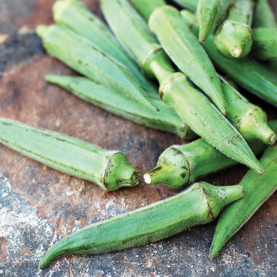 Long Pod Perkins okra pods, vibrant green on rustic wooden surface on Tampa Home & Garden Store