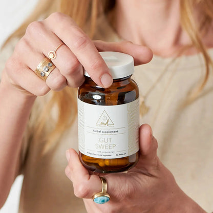 Gut Sweep herbal supplement bottle by OWL Venice, amber glass with white label on Tampa Home & Garden Store